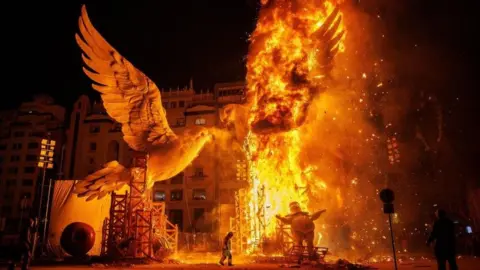 A papier-mache sculpture burns during the Nit de la Crema (Fire Night) of the Fallas Festival in Valencia, eastern Spain