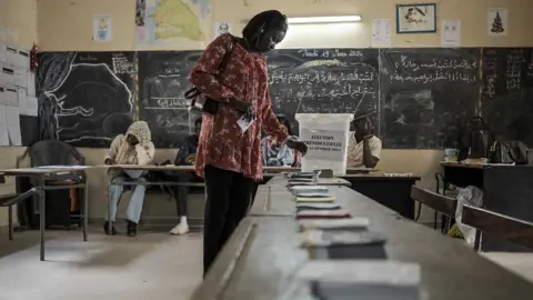 A voter casting her vote in Senegal's presidential election