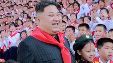 Kim Jong Un surrounded by children