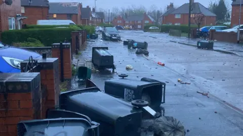 Bins and debris in the road