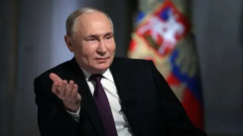 Russian President Vladimir Putin gives an interview to TV host and Director General of Rossiya Segodnya