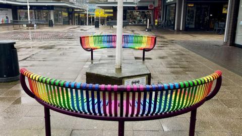 Two rainbow-coloured benches in Longton, Staffordshire.