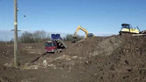 Trucks dumping waste