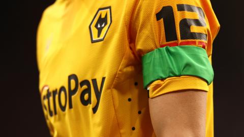 Players of Wolves are seen wearing a sustainable green arm band in support of green football weekend