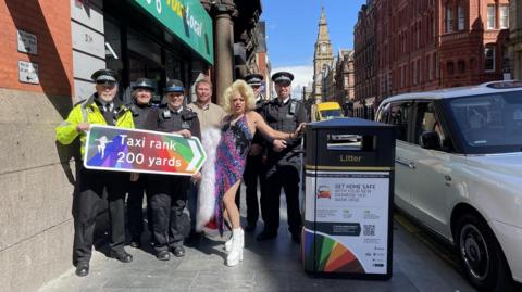 Representatives from the Liverpool City Centre Neighbourhood Policing Team, LCR Pride Foundation CEO Andi Herring, Liverpool drag queen Lady Sian, Liverpool City Centre Inspector Jack Woodward and Sergeant Craig Winstanley from Merseyside Police, at the new Rainbow Taxi Rank.