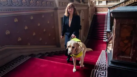 Victoria Harrison and guide dog, Otto, at the Foreign, Commonwealth & Development Office