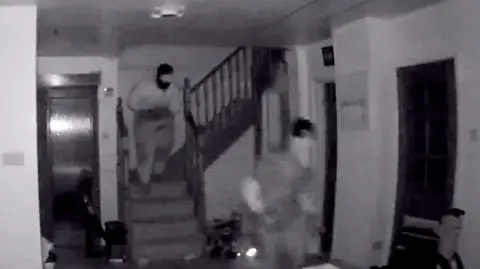 CCTV footage of two people in a house
