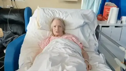 Jean Morgan in a hospital bed