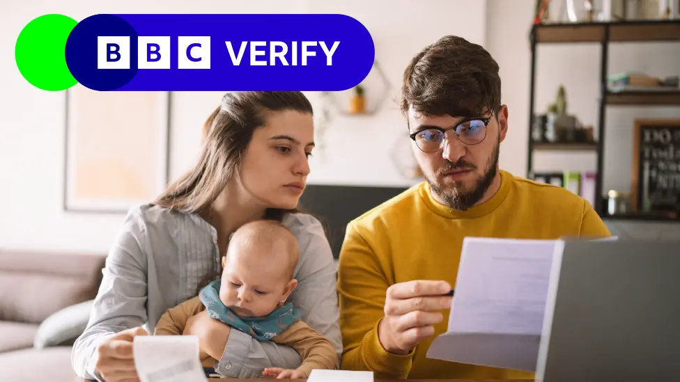 Parents with an infant looking at paperwork