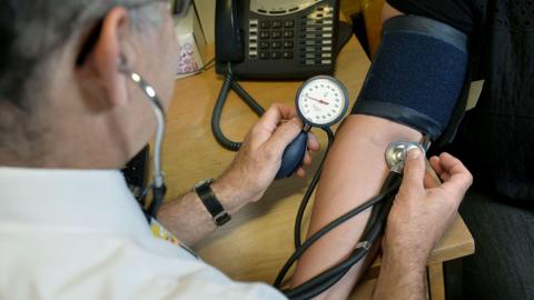 Generic picture of GP taking patient's blood pressure