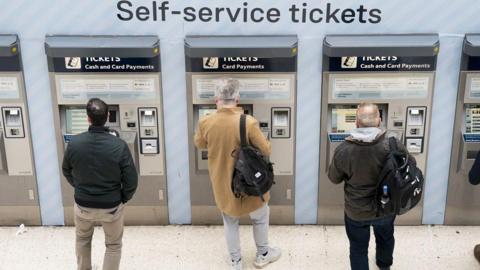 People using ticket machines