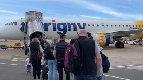 Queues outside Aurigny's Embraer jet