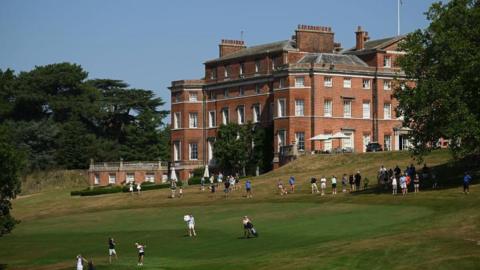 Golfers playing in front of Brocket Hall