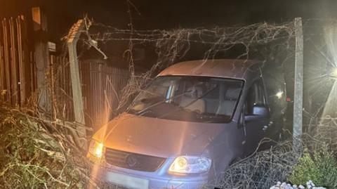 Van in fence