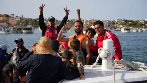 Migrants arrive in the harbour of Italian island of Lampedusa, on September 18, 2023