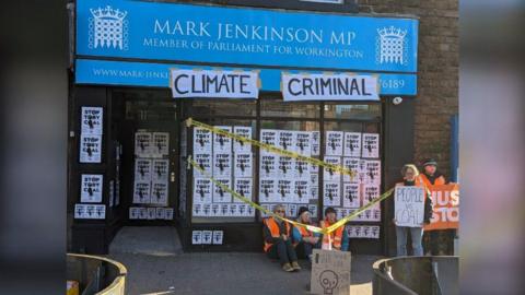 Just Stop Oil protesters sitting outside Mark Jenkinson MP's office 