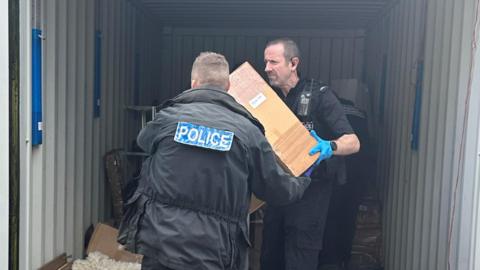 Police retrieving boxes