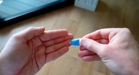 A man taking a finger prick test