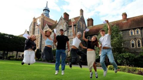 Students at Brighton College jump for joy on A-level results day
