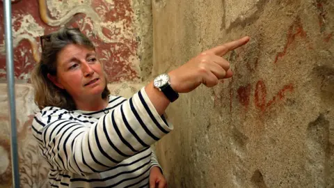 Archaeologist explains initials left on a wall