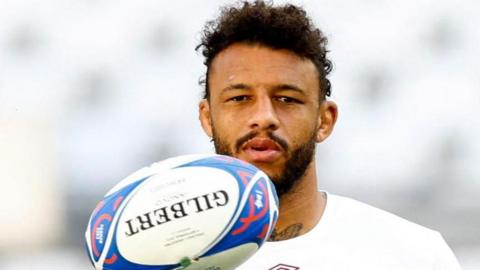 Courtney Lawes holding a rugby ball
