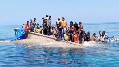 Rohingya refugees stranded on hull of capsized boat