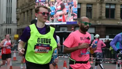 Blind man Yahya Pandor running the Manchester Marathon with vocal assistance from his guide