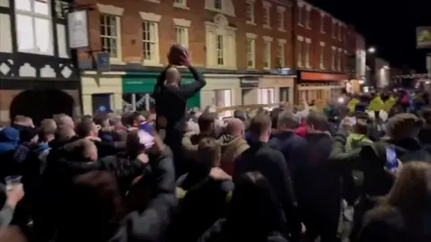 The Up'Ards celebrate their win Royal Shrovetide Football game in Ashbourne, Derbyshire.
