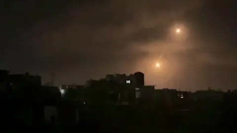 Flares over the city of Rafah at night