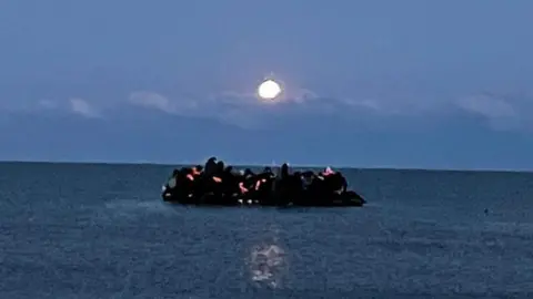 Migrants are packed on a boat in the sea off Wimereux near Boulogne in France