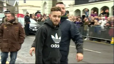 One Direction band member Liam Payne walking across road in Clevedon