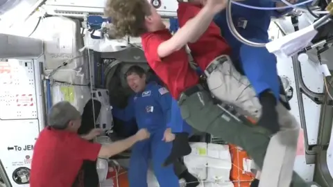 Astronauts embrace