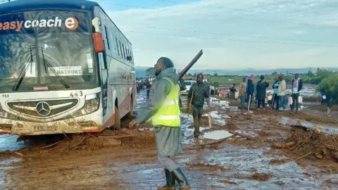 A bus caught up in the raging waters from the dam