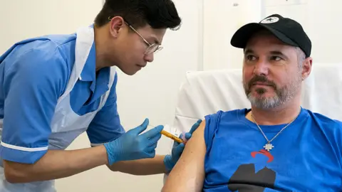 Steve Young receives a Melanoma jab from a healthcare professional at UCLH in London on 11 April