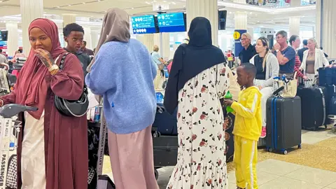 Passengers waiting at Dubai airport on 17 April