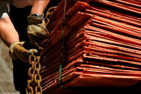 Worker secures copper plates at Anglo American mine in Chile 