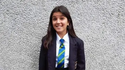Katy - young girl smiling, wearing a school uniform