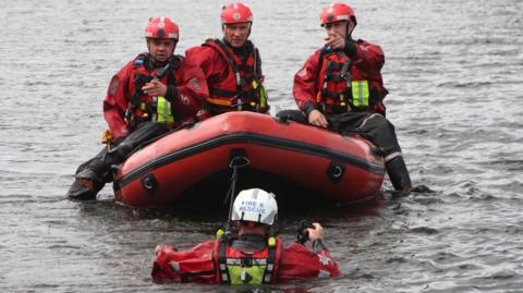 Surrey Fire and Rescue Service members staging a demonstration at Virginia Water