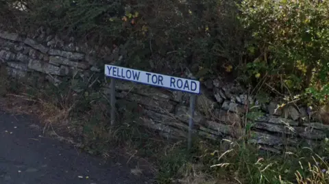 A signpost reading Yellow Tor Road