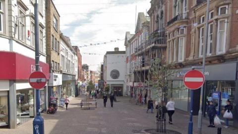 A Google maps image of Ramsgate High Street showing brick pavements and shops flanking either side of the street. 