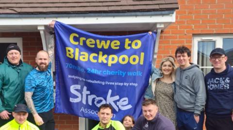 The walkers with charity flag