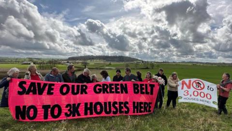 Campaigners on the proposed site of housing