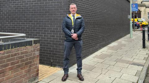 Man standing outside Gloucester Police station