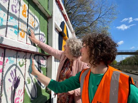 People making hand prints in solidarity with the Alliance project