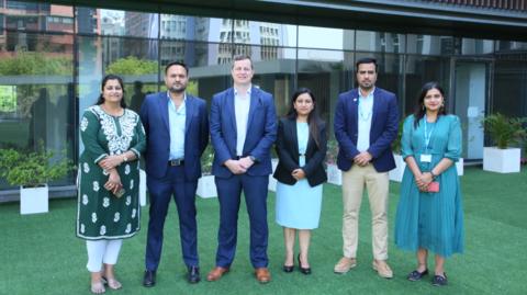 Staff outside the new offices