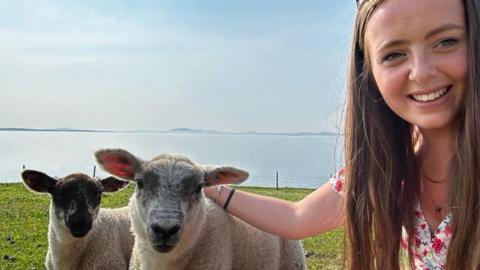 Sarah Campbell and lambs
