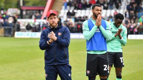 Darrell Clarke applauds fans alongside Cheltenham players after full-time