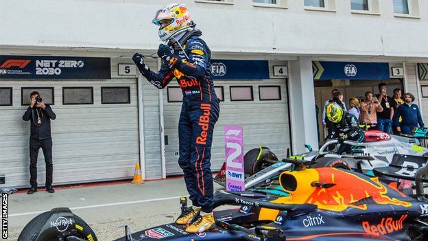 Max Verstappen celebrates on car
