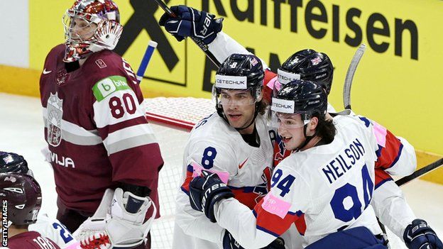 Great Britain celebrate a goal against Latvia at the Ice Hockey World Championship