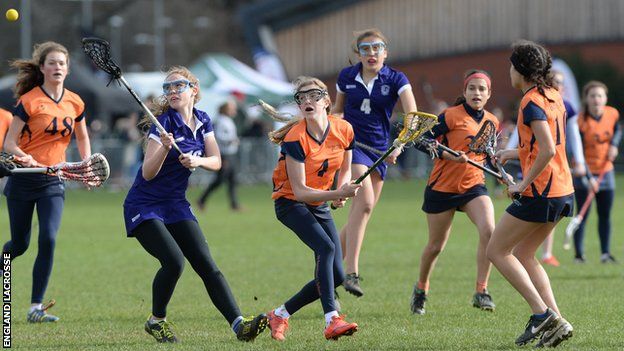 Young women playing lacrosse